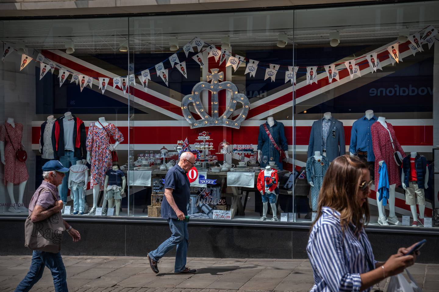 People walk past a shop window display commemorating the platinum jubilee in Windsor. Getty Images