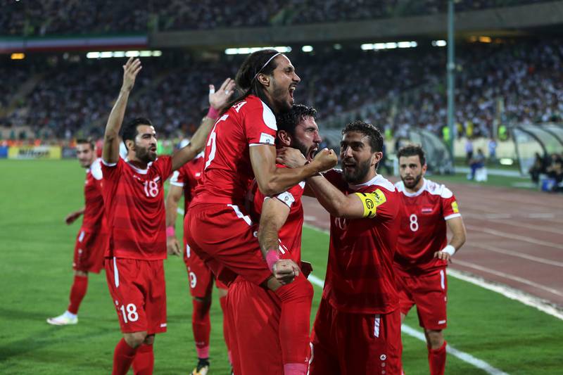 Syria's soccer team celebrates after scoring a goal against Iran during their Round 3 - Group A World Cup qualifier at the Azadi Stadium in Tehran, Iran, Tuesday, Sept. 5, 2017. The match draw 2-2. (AP Photo/Vahid Salemi)