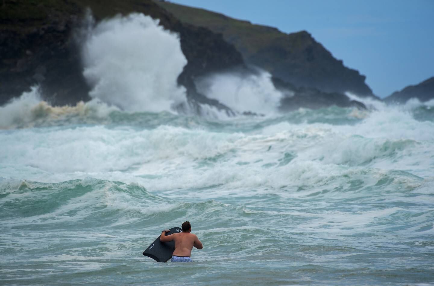 Bodyboarders brave the waves in rough seas in Newquay during Storm Evert earlier this year. Getty Images
