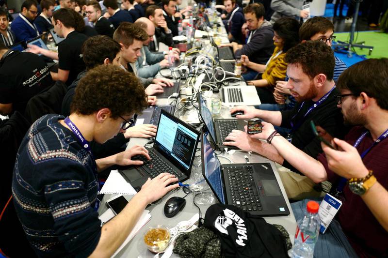 Cyber Security experts take part in a test at the Cybersecurity Conference in Lille, northern France, Tuesday Jan. 22, 2019. The forum's scientific program sets out to encourage brainstorming and dialogue aiming to promote a European vision of cybersecurity and to strengthen the fight against cybercrime. (AP Photo/Michel Spingler)