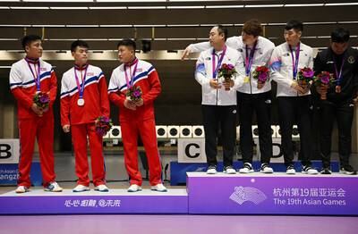 Asian Games shooting gold medallists South Korea alongside silver medallists North Korea, in China. Reuters