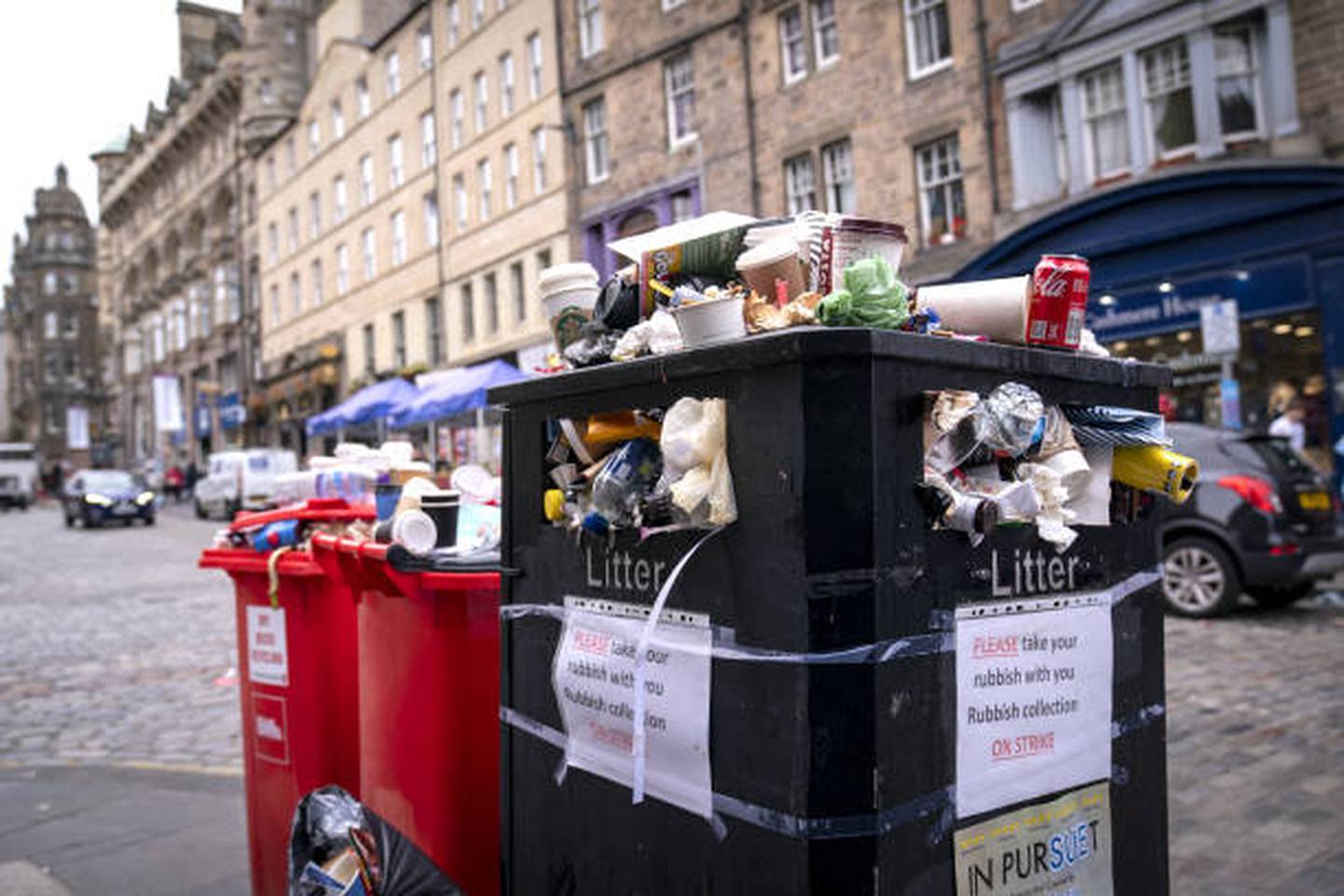Bins overflowing with litter on the Canongate in Edinburgh city centre after a strike by refuse workers. PA