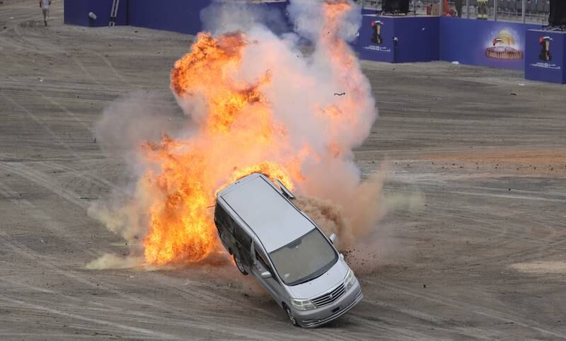 A vehicle is flipped during a demonstration of an explosion.   EPA