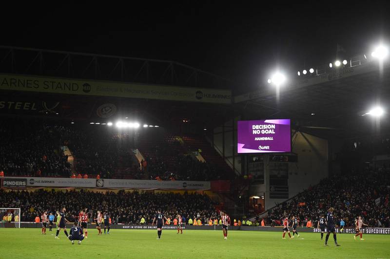 The big screen shows the VAR decision ruling out a goal by West Ham United's Scottish midfielder Robert Snodgrass because of a handball in the build up. AFP