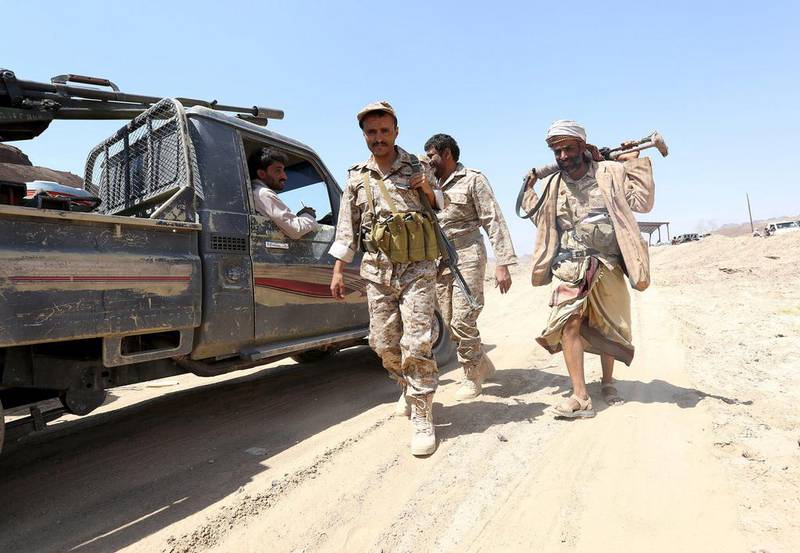 Soldiers loyal to Yemen's government walk at the frontline of fighting against Houthi militants in the central province of Marib on Tuesday. Stringer / Reuters