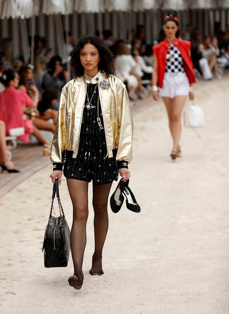 Gold bomber jackets and chequered tops at the Chanel cruise 2022/23 show. Photo: EPA