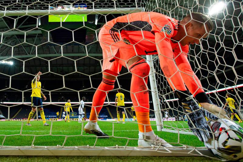 Sweden goalkeeper Robin Olsen picks the ball out of the net after France's Kylian Mbappe scored. AFP