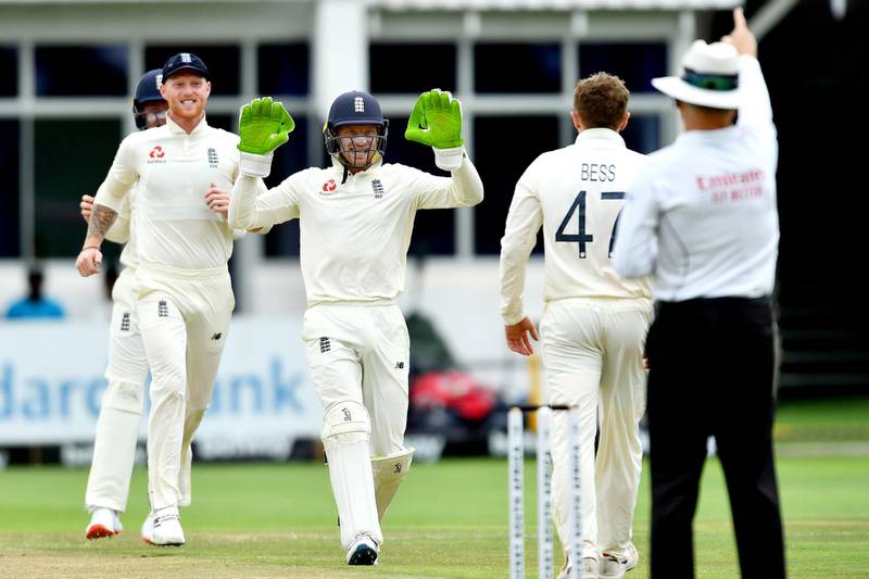 Left to right: Ben Stokes  and Jos Buttler celebrate after Dom Bess claimed the wicket of Dean Elgar. Getty