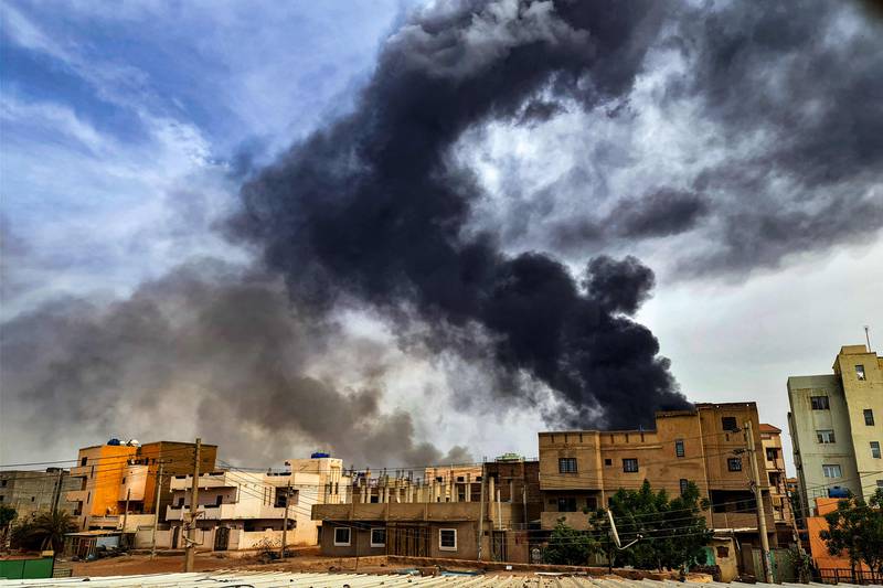 Smoke billows from a fire at warehouse in southern Khartoum on June 7. The war between Sudan's army and its paramilitary rivals in the Rapid Support Forces reached the six-month point this week. AFP