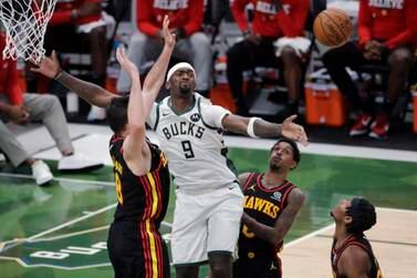 Milwaukee Bucks' Bobby Portis (9) loses control of the ball between multiple Atlanta Hawks defenders during the second half of Game 5 of the NBA basketball playoffs Eastern Conference finals Thursday, July 1, 2021, in Milwaukee.  (AP Photo / Aaron Gash)