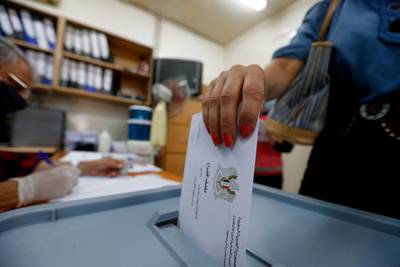 A woman casts her ballot at a polling station in the Syrian capital Damascus during parliamentary elections. AFP