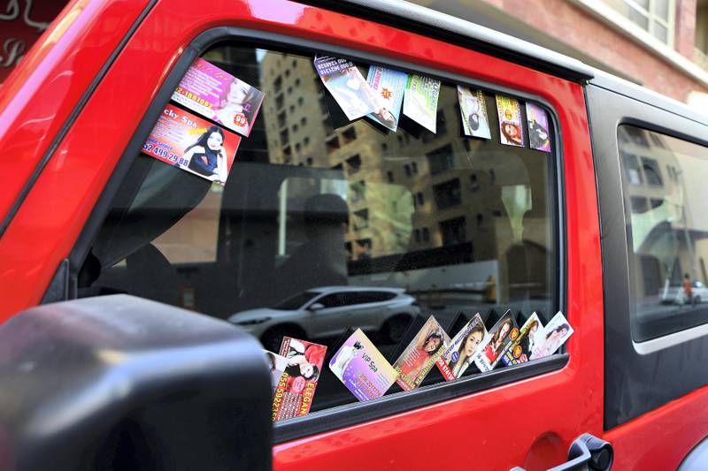 DUBAI , UNITED ARAB EMIRATES , AUG 14 – 2017 :- Massage cards on the window of a car parked in the Al Barsha area in Dubai. ( Pawan Singh / The National ) Story by Nawal Ail Ramahi