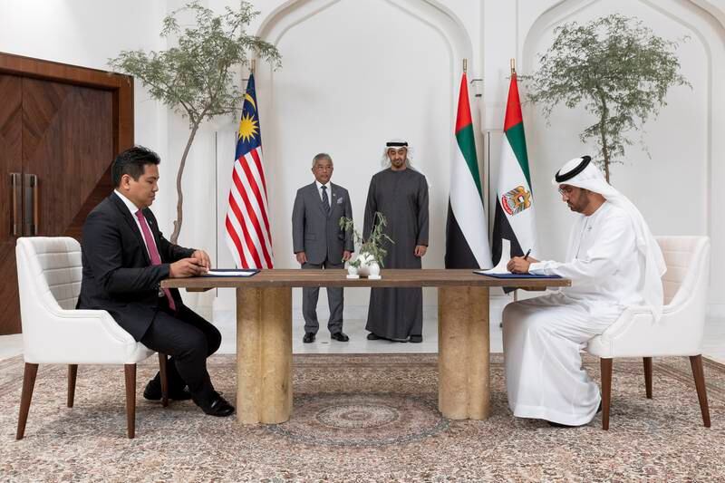 President Sheikh Mohamed and Malaysia's king, Sultan Abdullah Sultan Ahmad Shah, witness the signing of the agreement by Dr Sultan bin Ahmed Al Jaber, Minister of Industry and Advanced Technology and Adnoc’s managing director and group chief executive, and Datuk Tengku Muhammad Taufik, president and group chief executive of Petronas. Photo: UAE Presidential Court