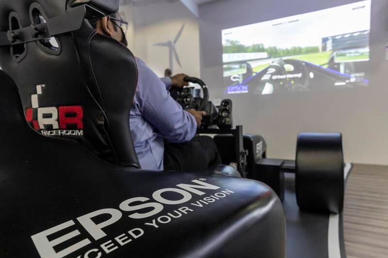 A visitor tries out a simulation of a racing car.