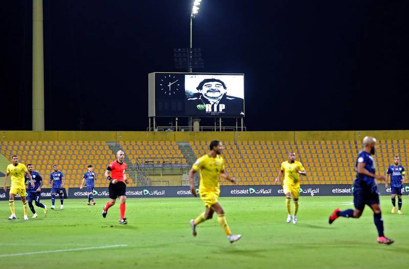 A picture of late Argentinian football legend Diego Armando Maradona is seen on the stadium sceen at the Zabeel Stadium in the Emirati city of Dubai on November 26, 2020, during a league match between Al-Wasl and Fujairah. / AFP / -
