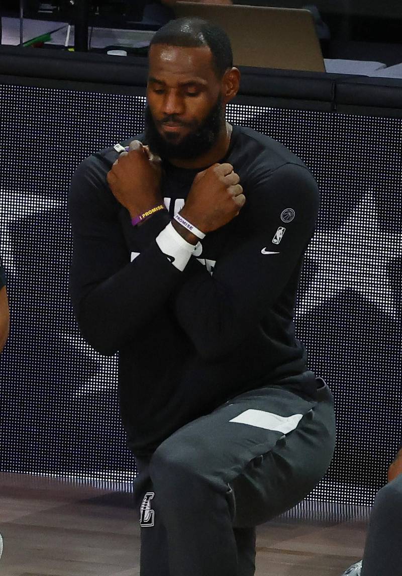 Los Angeles Lakers star LeBron James crosses his arms for the Wakanda salute during a moment of silence to honour the death of actor Chadwick Boseman before the start of game five against the Portland Trail Blazers during the 2020 NBA Playoffs. Getty Images / AFP