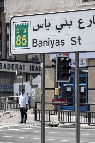 DUBAI, UNITED ARAB EMIRATES. 26 APRIL 2020. The barrier along the Baniyas road entrance to the quarentined Al Ras area in Deira. A man walks along the barrier. (Photo: Antonie Robertson/The National) Journalist: Ramola Talwar. Section: National.