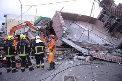 In this photo provided by Hualien City Government, firefighters are seen at a collapsed building during a rescue operation following an earthquake in Yuli township, Hualien County, eastern Taiwan, Sunday, Sept.  18, 2022.  A strong earthquake shook much of Taiwan on Sunday, toppling at least one building and trapping two people inside and knocking part of a passenger train off its tracks at a station. (Hualien City Government via AP)