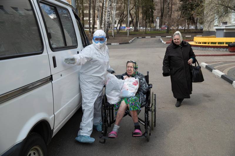 A medical worker helps an elderly woman to get in a car as she was released from the intensive care unit of the hospital of Vinogradov City Clinical Hospital in Moscow, Russia. Reports of Russian medical workers becoming infected with the coronavirus are emerging almost daily as the country copes with a growing number of patients. AP