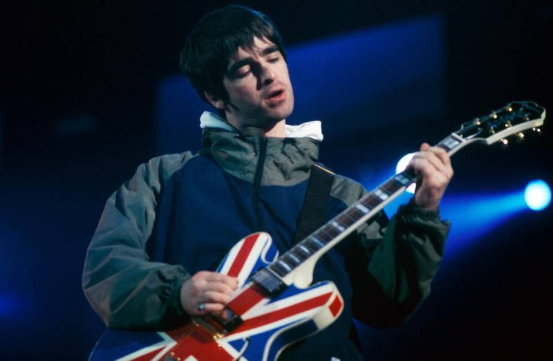 UNITED KINGDOM - APRIL 01:  MAINE ROAD  Photo of OASIS and Noel GALLAGHER, Noel Gallagher performing on stage, Union Jack Epiphone guitar  (Photo by Patrick Ford/Redferns)