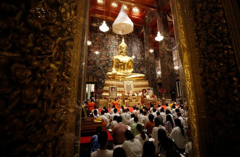 Buddhists pray during New Year's Eve celebrations at Wat Suthat Thepwararam temple in Bangkok, Thailand. Reuters