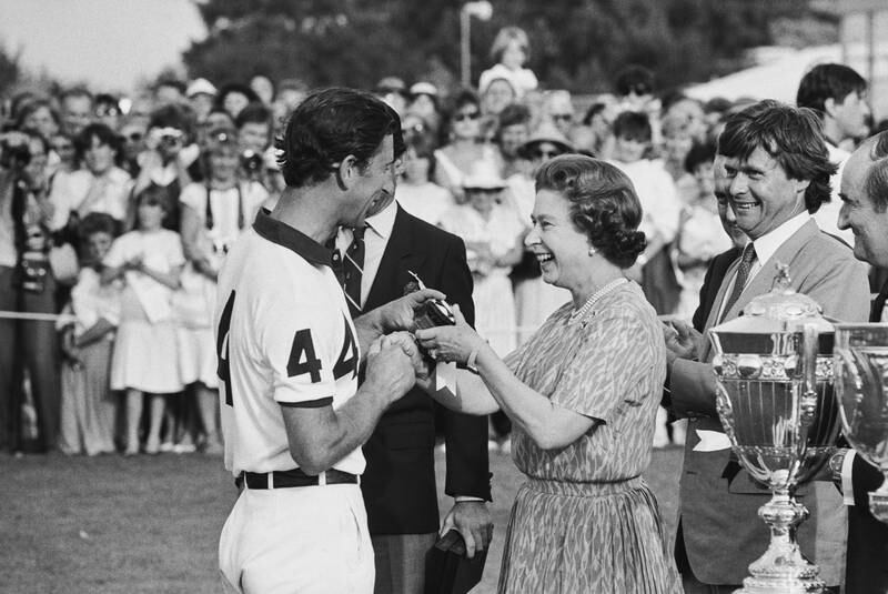 Prince Charles is presented with an award by his mother after a polo match in 1984. Getty
