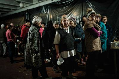 Internally displaced people wait to receive food inside a factory that has been turned into a shelter, in Severodonetsk. AFP