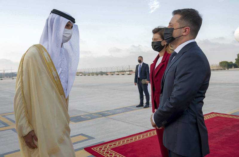 ABU DHABI, UNITED ARAB EMIRATES - February 13, 2021: HE Abdulla Bin Touq Al Marri, UAE Minister of Economy (L), receives HE Volodymyr Zelenskyy, President of Ukraine (R), at the Presidential Airport.( Mohamed Al Hammadi / Ministry of Presidential Affairs )---