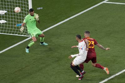 Roma's Gianluca Mancini, right, scores an own goal to level the scores. AP 