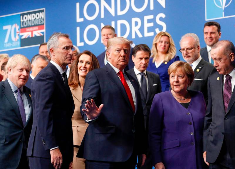 Britain's Prime Minister Boris Johnson (L), US President Donald Trump (C), German Chancellor Angela Merkel (2R), Turkey's President Recep Tayyip Erdogan (R) and other NATO leaders leave the stage after the family photo to head to the plenary session at the NATO summit at the Grove hotel in Watford, northeast of London on December 4, 2019. / AFP / POOL / PETER NICHOLLS
