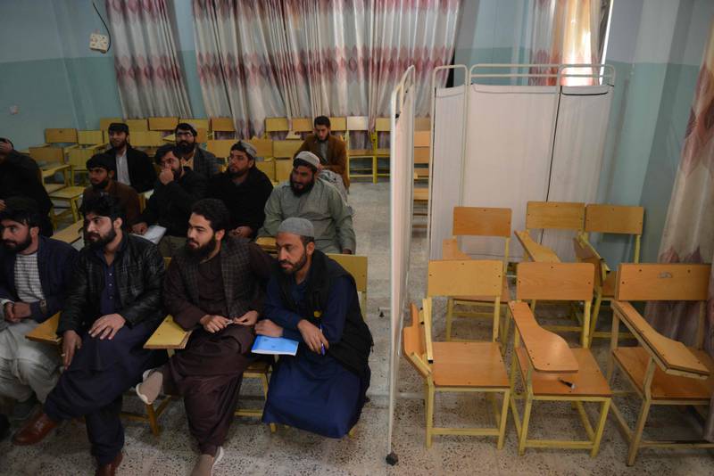 A curtain separates males and females at a university lecture in Kandahar Province. AFP