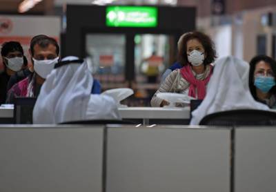 Passengers have their travel documents checked before departure at Dubai International Airport.