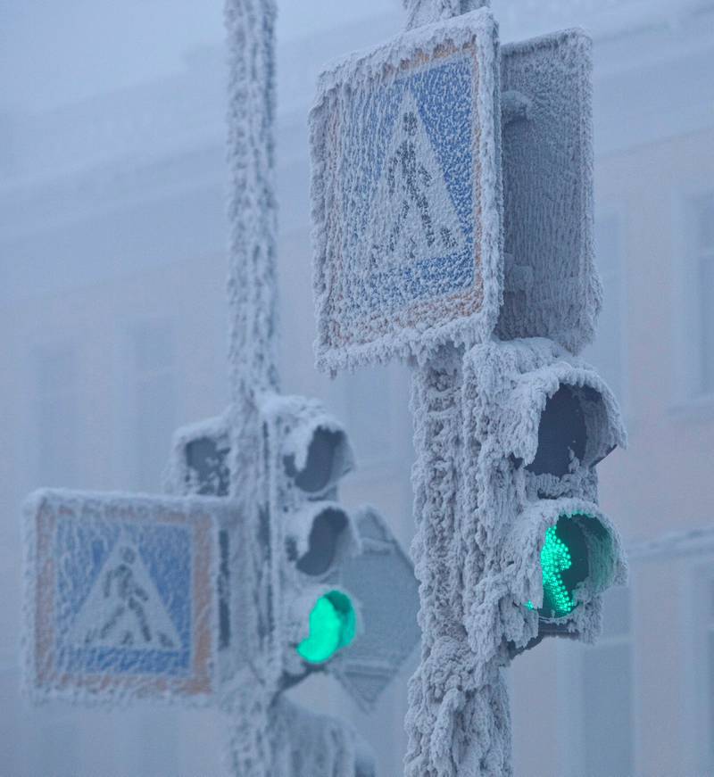Traffic lights pierce the mist. Reuters