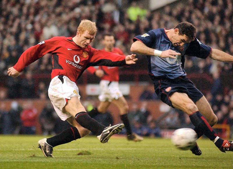 Paul Scholes (left) of Manchester United blasts the ball past Martin Keown of Arsenal to score the second goal for Manchester United, during the Barclaycard Premiership Match at Old Trafford, Manchester.  Manchester United won the game 2-0.  THIS PICTURE CAN ONLY BE USED WITHIN THE CONTEXT OF AN EDITORIAL FEATURE. NO WEBSITE/INTERNET USE UNLESS SITE IS REGISTERED WITH FOOTBALL ASSOCIATION PREMIER LEAGUE.   (Photo by John Giles - PA Images/PA Images via Getty Images)