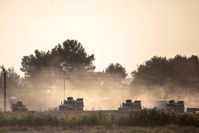 Turkish army vehicles drive towards the Syrian border near Akcakale in Sanliurfa province. AFP