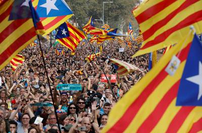 People gather as they watch on giant screens a plenary session outside the Catalan regional parliament in Barcelona, Spain, October 27, 2017. REUTERS/Yves Herman