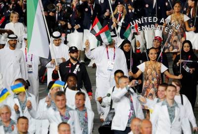 UAE flag bearer Saeed Almaktoum holds the national flag as he leads the contingent in the athletes parade during the opening ceremony of the London 2012 Olympic Games at the Olympic Stadium July 27, 2012. REUTERS/Mike Blake (BRITAIN  - Tags: SPORT OLYMPICS)   *** Local Caption ***  OLYAF98_OLY-OPEN-CE_0728_11.JPG