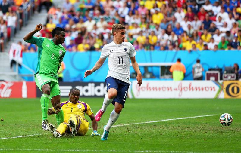 Joseph Yobo of Nigeria, left, scores an own goal as goalkeeper Vincent Enyeama and Antoine Griezmann of France look on during their match on Monday at the 2014 World Cup. Jeff Gross / Getty Images