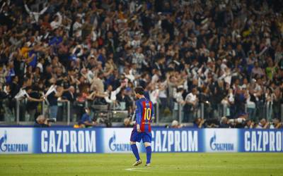 Barcelona's Lionel Messi looks dejected as Juventus fans celebrate. Stefano Rellandini / Reuters