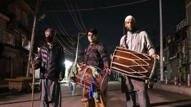Mohammad Rafiq Katariya, left, stands with his fellow Ramadan drummers on a deserted street in the middle of the night at Alamgari Bazar, an old residential area, in Srinagar, Kashmir. Adil Abbas for The National