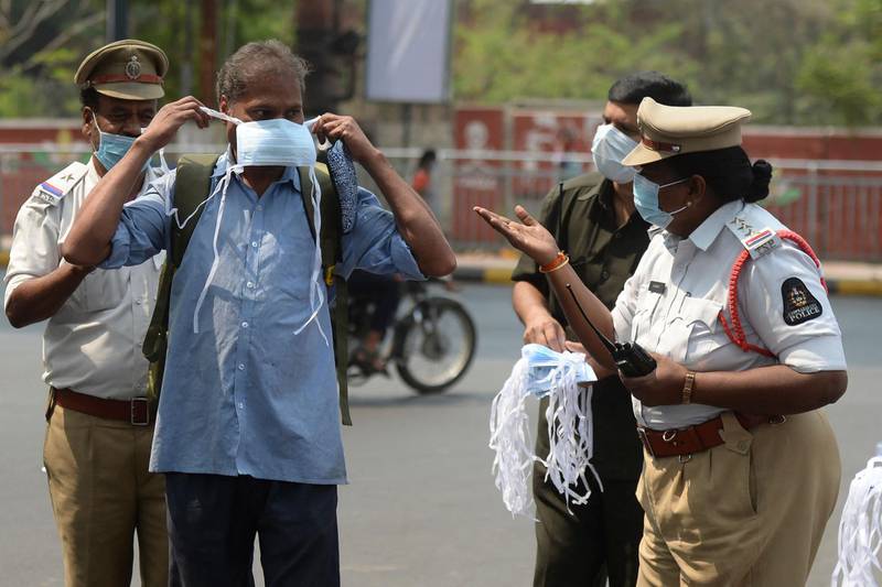 A woman police officer tells a man to wear face mask during an awareness campaign against the spread of Covid-19 at a traffic junction in Hyderabad, India, on April 7, 2021. AFP