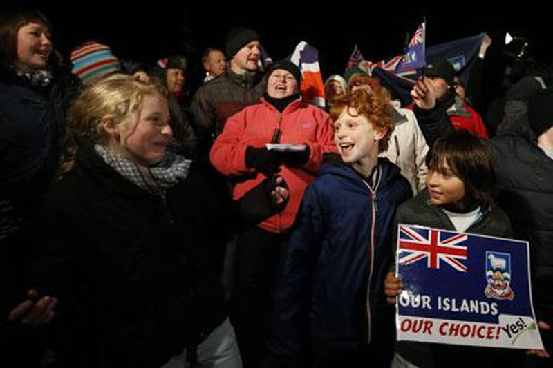 People celebrate in the Falkland Islands on Monday after the results from the referendum on whether they want to continue under British sovereignty were released. EPA