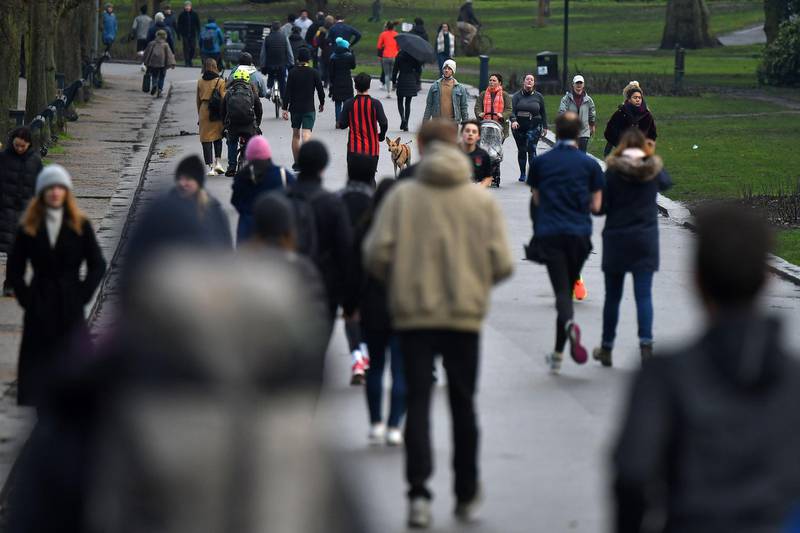 People walk in Victoria Park in east London. AFP