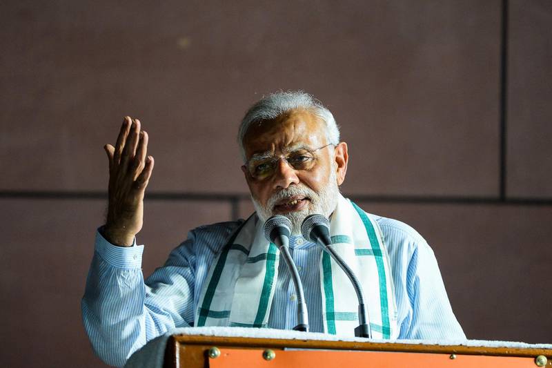 Indian Prime Minister Narendra Modi addresses party supporters during a celebration event ahead of wining the Karnataka election in New Delhi on May 15, 2018. India's opposition Congress party suffered an electoral setback May 15 in one of the last major states which it governs and scrambled to build a coalition to stop Prime Minister Narendra Modi's party taking over. Modi's Bharatiya Janata Party (BJP) won most seats in Karnataka but fell short of a clear majority in the state of 60 million people, which includes the wealthy global IT hub of Bangalore. / AFP / CHANDAN KHANNA
