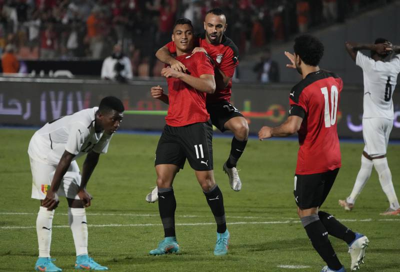 Egypt's players celebrate after scoring their goal against Guinea during their soccer match in Group D 2023 Cup of Nations (AFCON) qualifiers at Cairo International stadium in Cairo, Egypt.  Egypt won 1-0. AP Photo