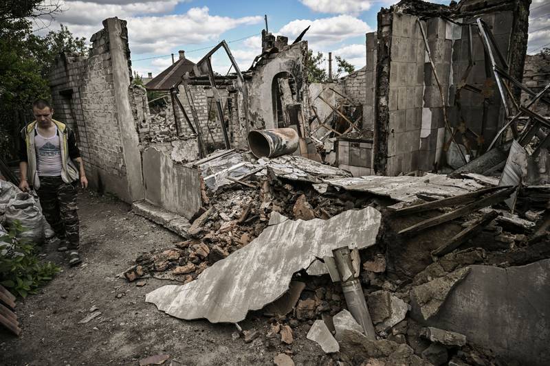 Ivan Sosnin, 19, surveys the damage to his home in Lysychansk. AFP