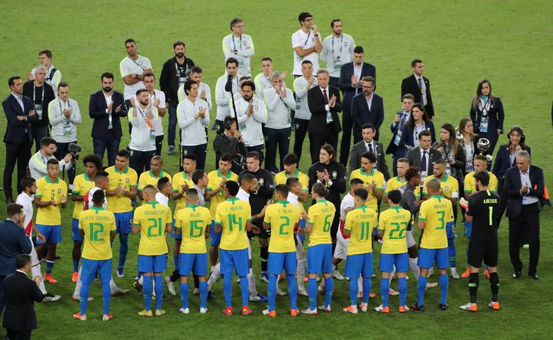 Brazil players applaud the Peru team. Reuters