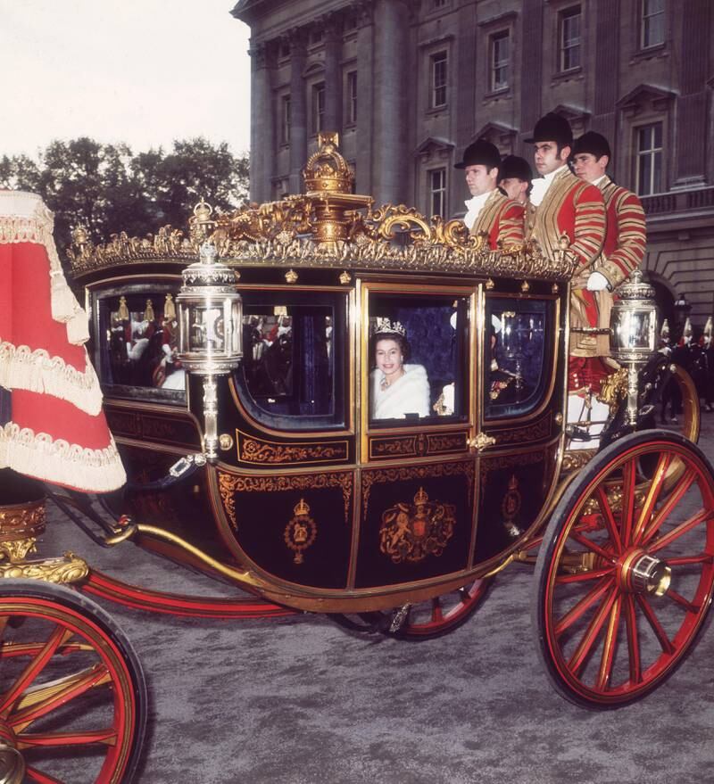 June 2, 1977:  Livery-clad coachmen accompany the state coach bearing Queen Elizabeth II on her Silver Jubilee. Getty
