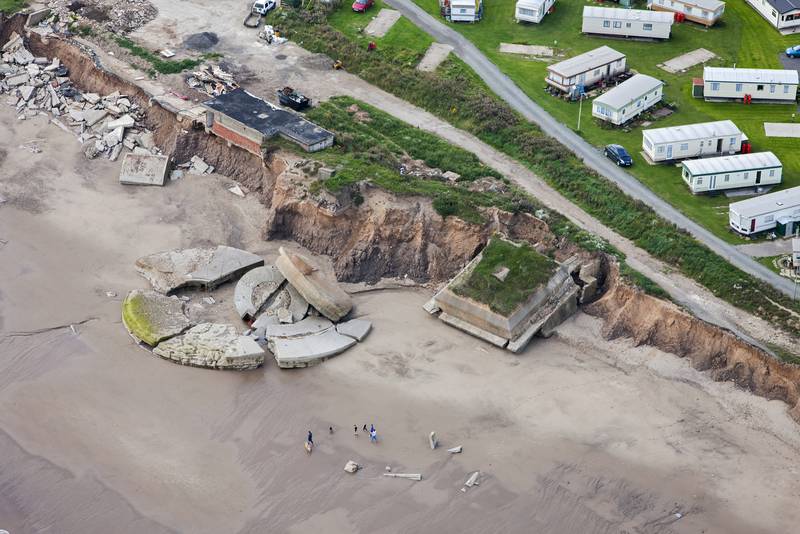 The East Yorkshire coastline is rapidly eroding, and several metres of land can be lost during years of extreme weather. This image shows the remains of Fort Godwin in 2009, a coastal gun battery that was active during both World Wars and was built inland. The coastline has receded to the extent that some buildings teeter on the cliff and large parts, including one circular gun emplacement, are on the beach