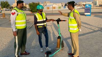 Dubai Police officers rewarded e-scooter riders with a special pin and certificate for adhering to safety traffic rules. Photo: Dubai Police